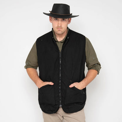 Man wearing a black vest and hat on a white background